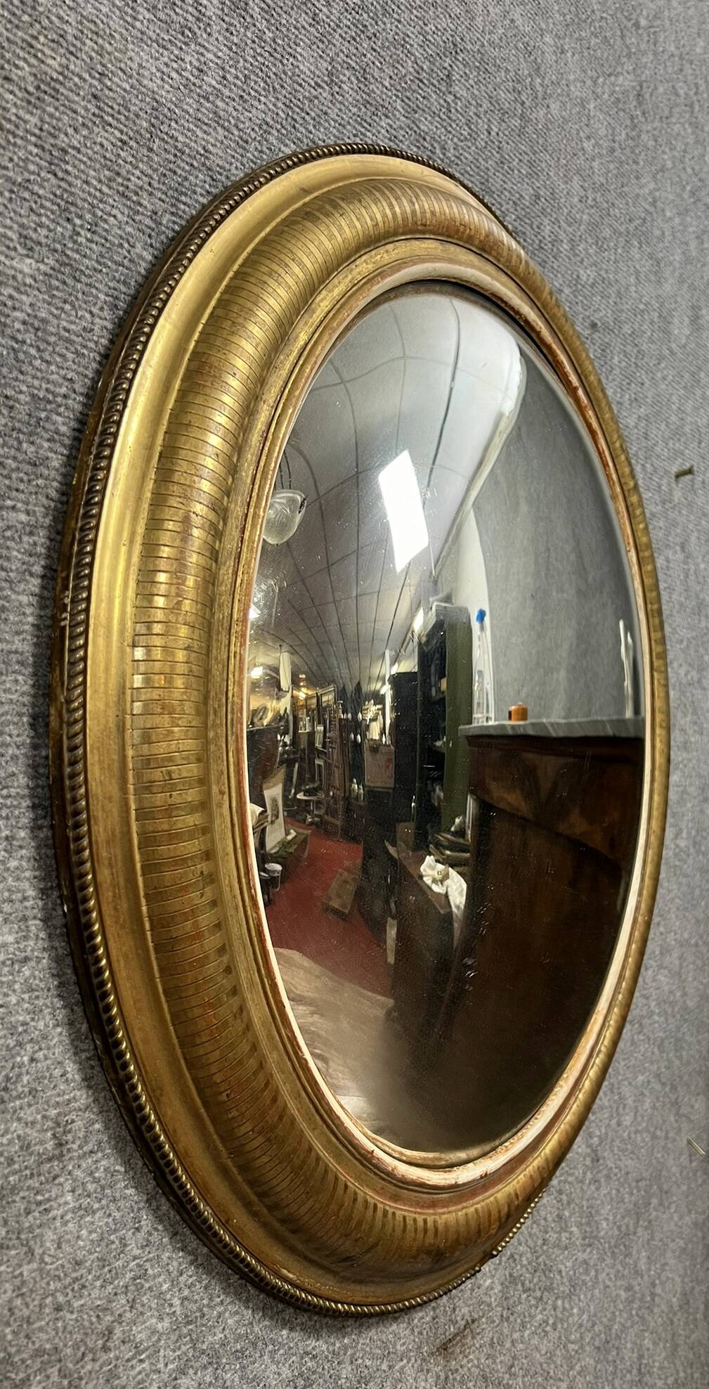 Oval mirror called “witch’s eye” in gilded wood in Louis XVI style circa 1850