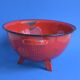 Vintage red enameled sheet metal colander