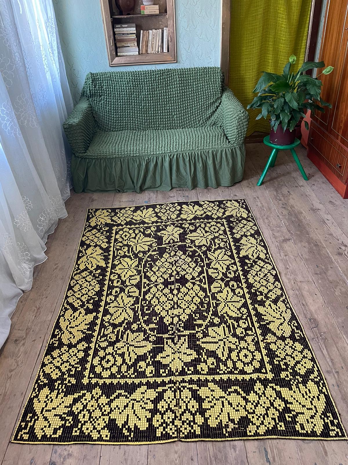 Romanian floral rug handwoven in wool, yellow and black background