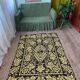 Romanian floral rug handwoven in wool, yellow and black background