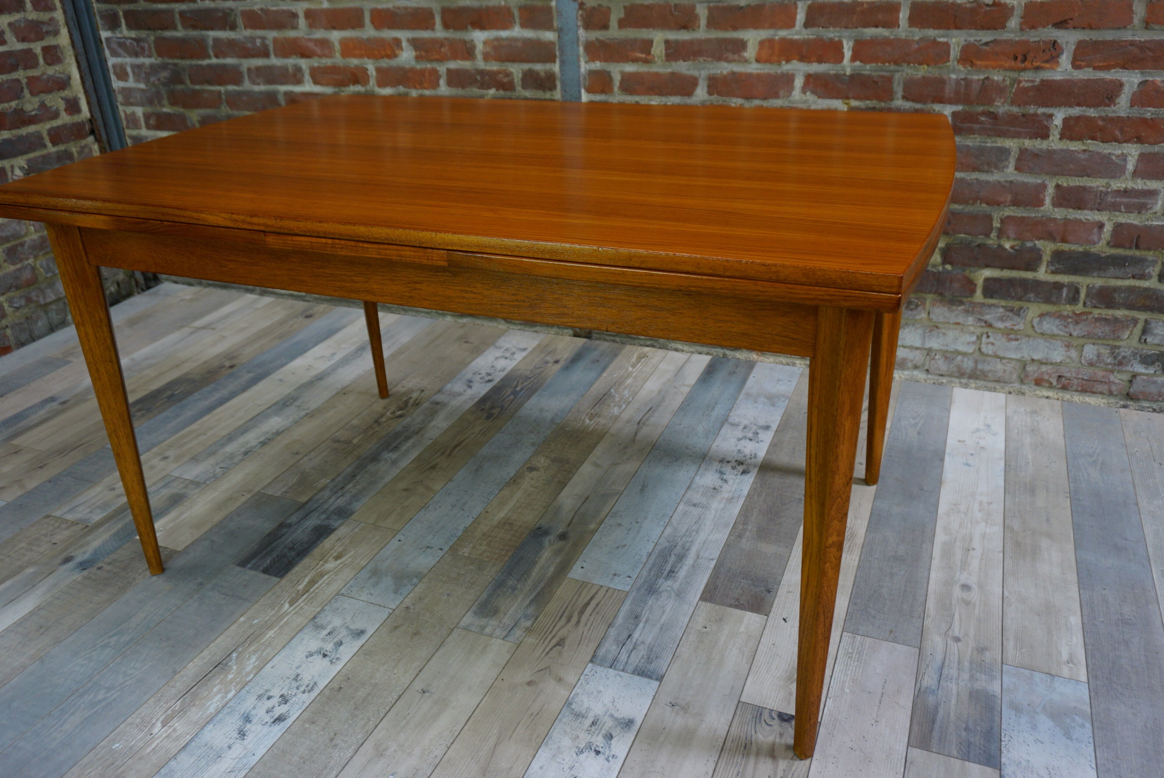 Teak dining table design by Johannes Andersen for Samcom 60s