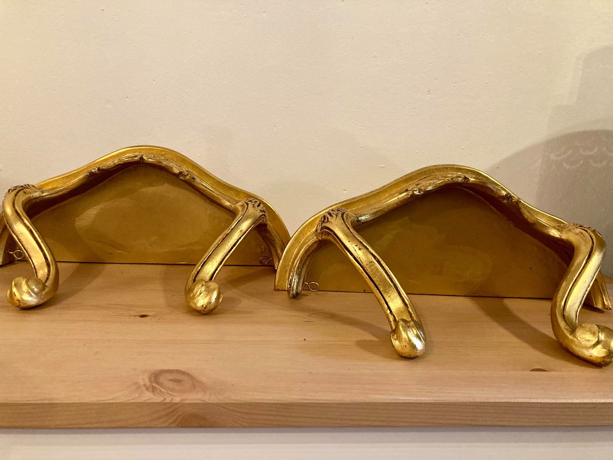 Pair of gilded wall shelves