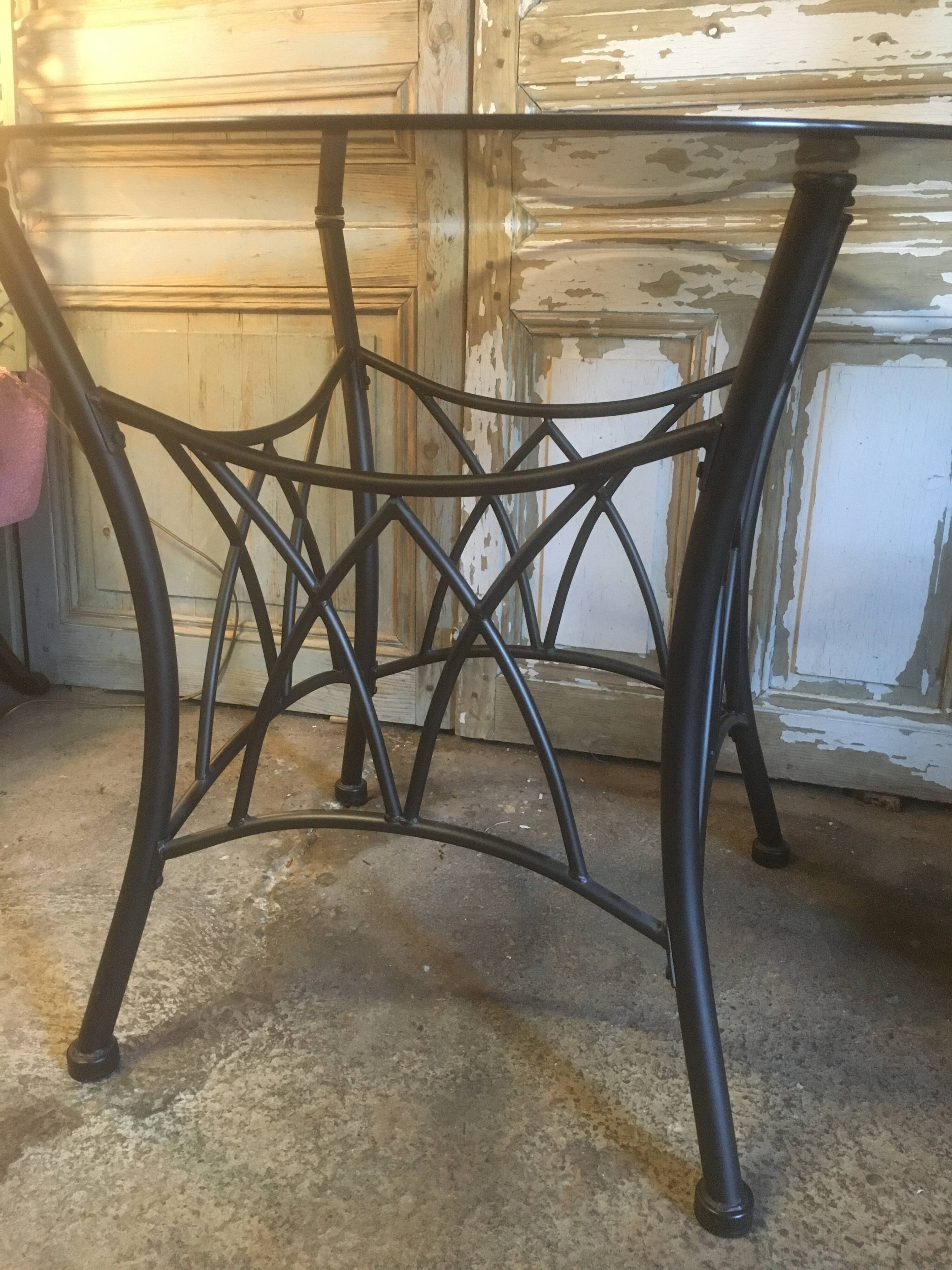 Round table with metal legs and smoked glass