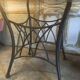 Round table with metal legs and smoked glass.