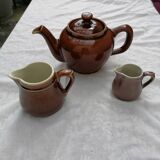 Brown ceramic teapot and milk jugs