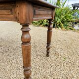 Old French farmhouse table in walnut with turned legs.