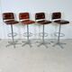 1970s chrome bar stools with cognac-colored faux leather upholstery