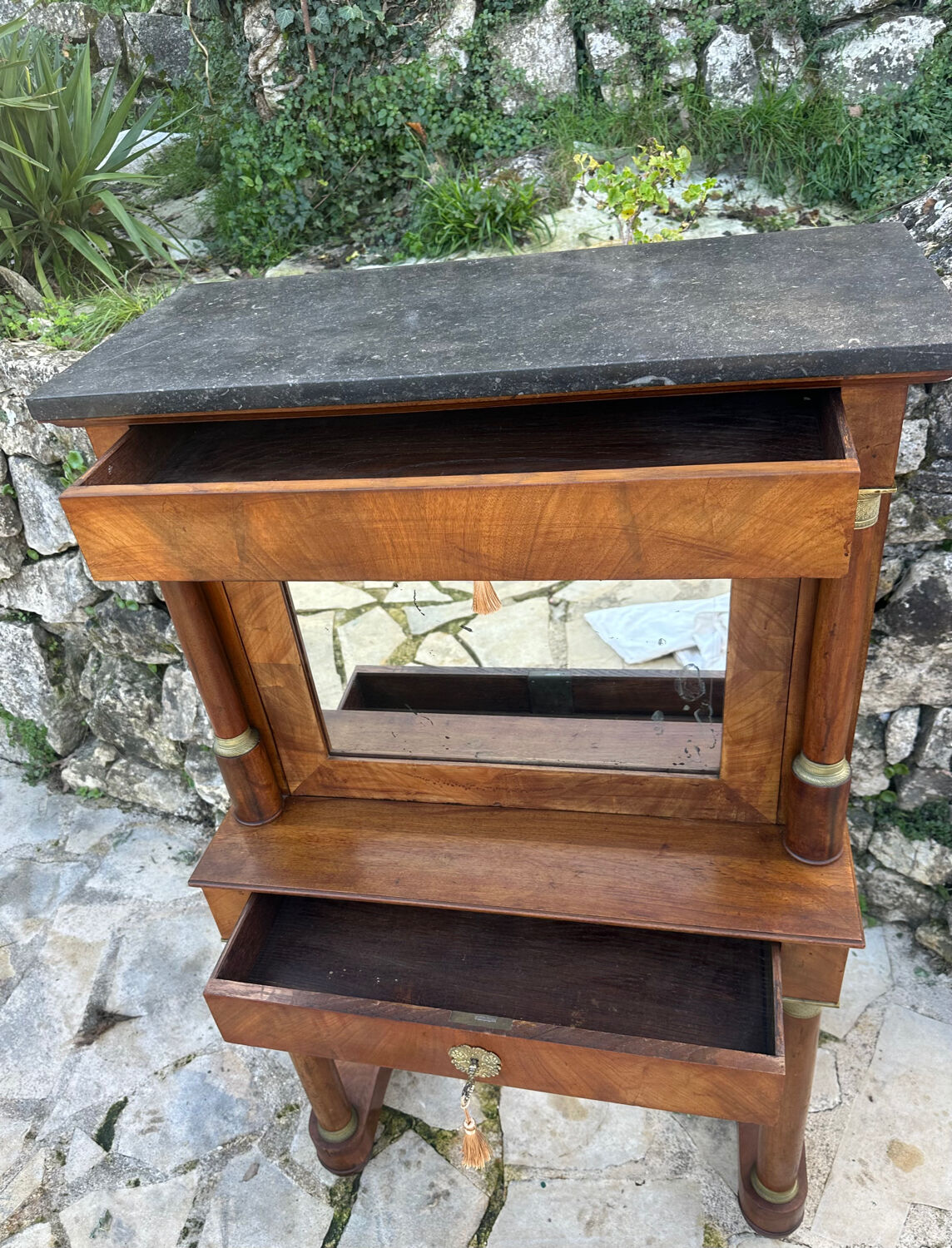 A small piece of Bonheur du jour with detached columns in Empire-era mahogany.