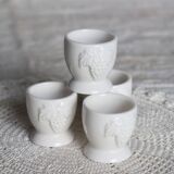 Vintage white porcelain egg cups with fruit motif.