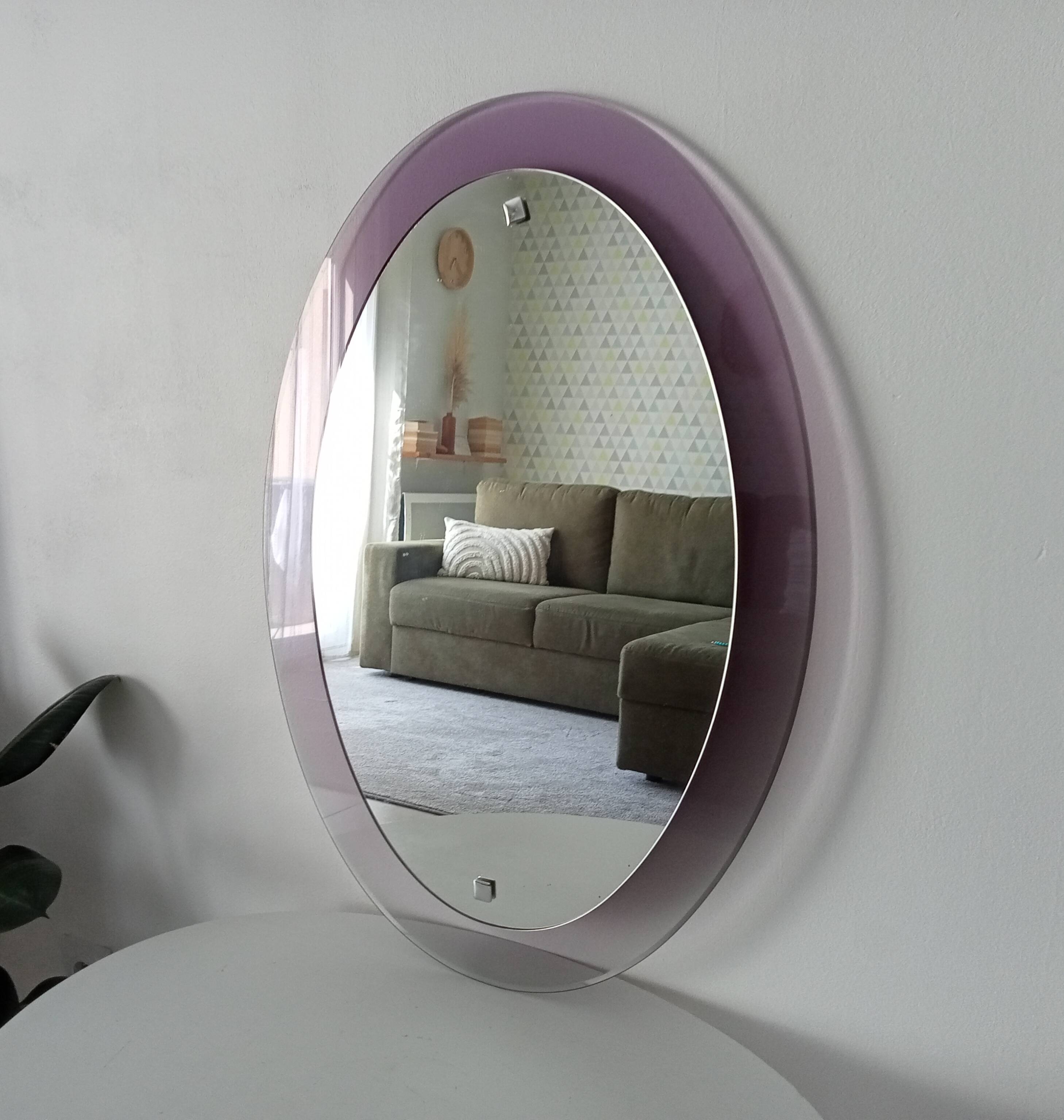 Vintage oval plexiglass mirror from the 70s by Harvey Guzzini