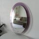Vintage oval plexiglass mirror from the 70s by Harvey Guzzini