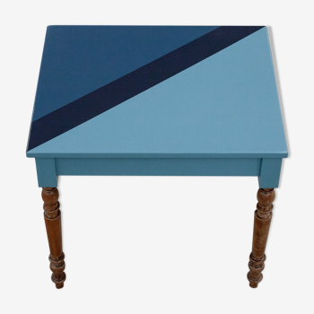 Wooden desk table with blue-shaped design