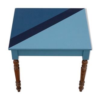 Wooden desk table with blue-shaped design