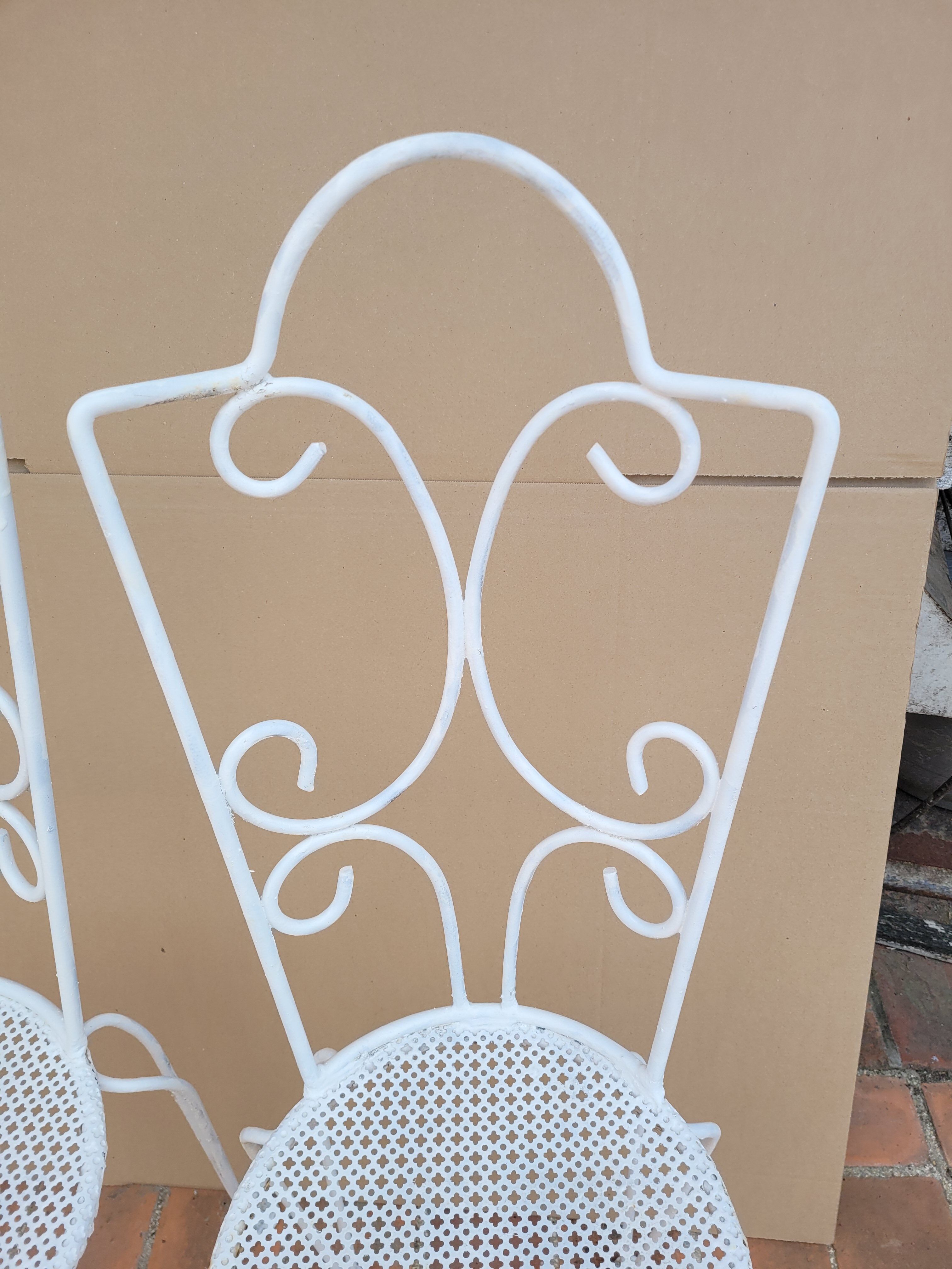 Pair of antique wrought iron garden chairs