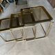 Brass nesting tables with smoked glass tops