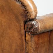 Sheepskin armchair with a beautiful vintage look and decorative nail finish