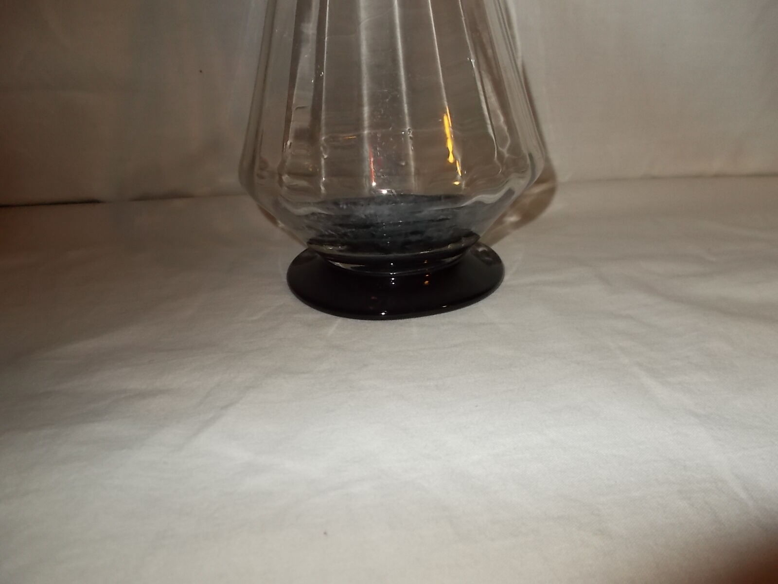 Dark purple glass wine carafe with a stopper.