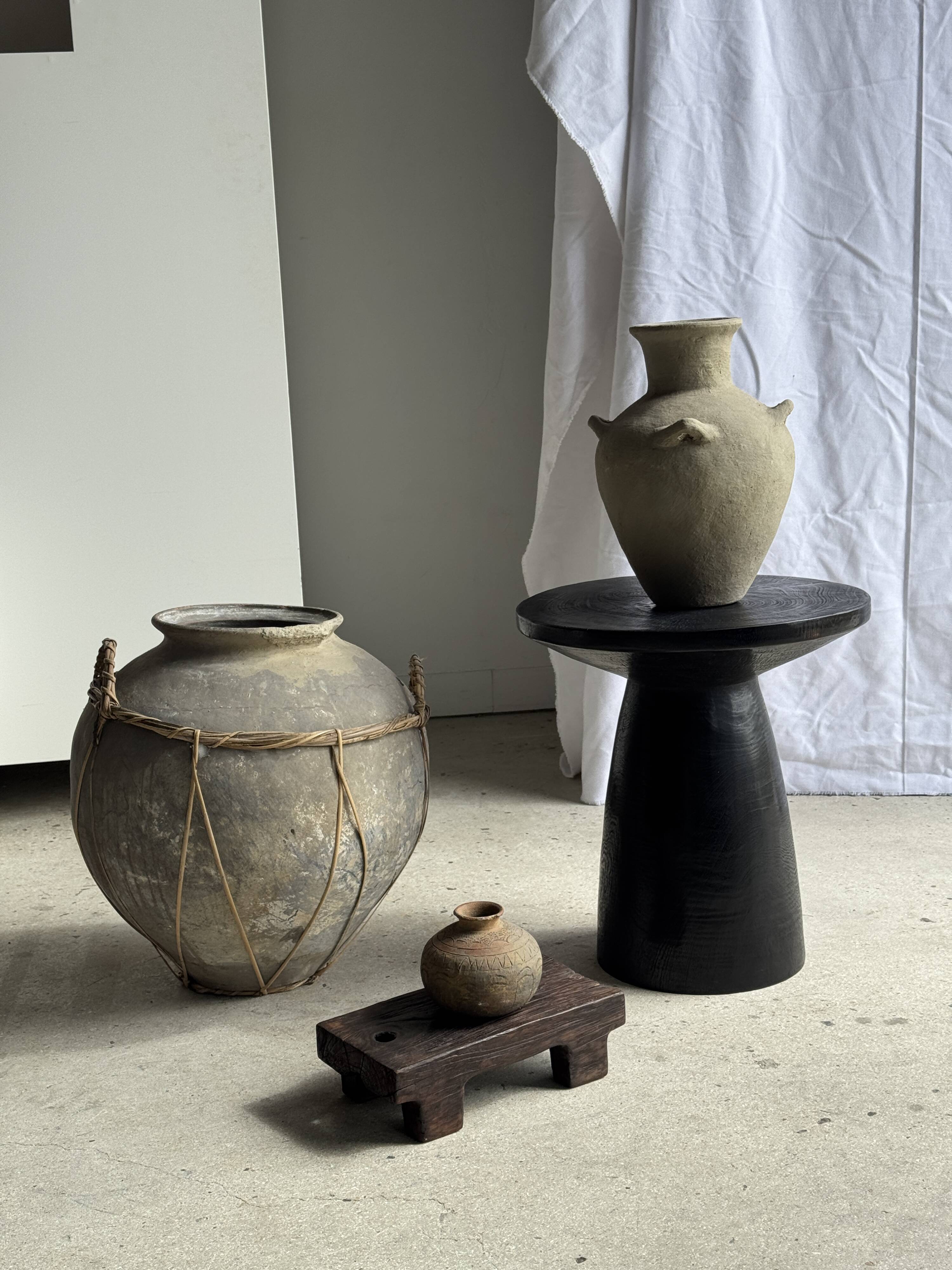 Black solid mango side table (monoxyle) with conical legs