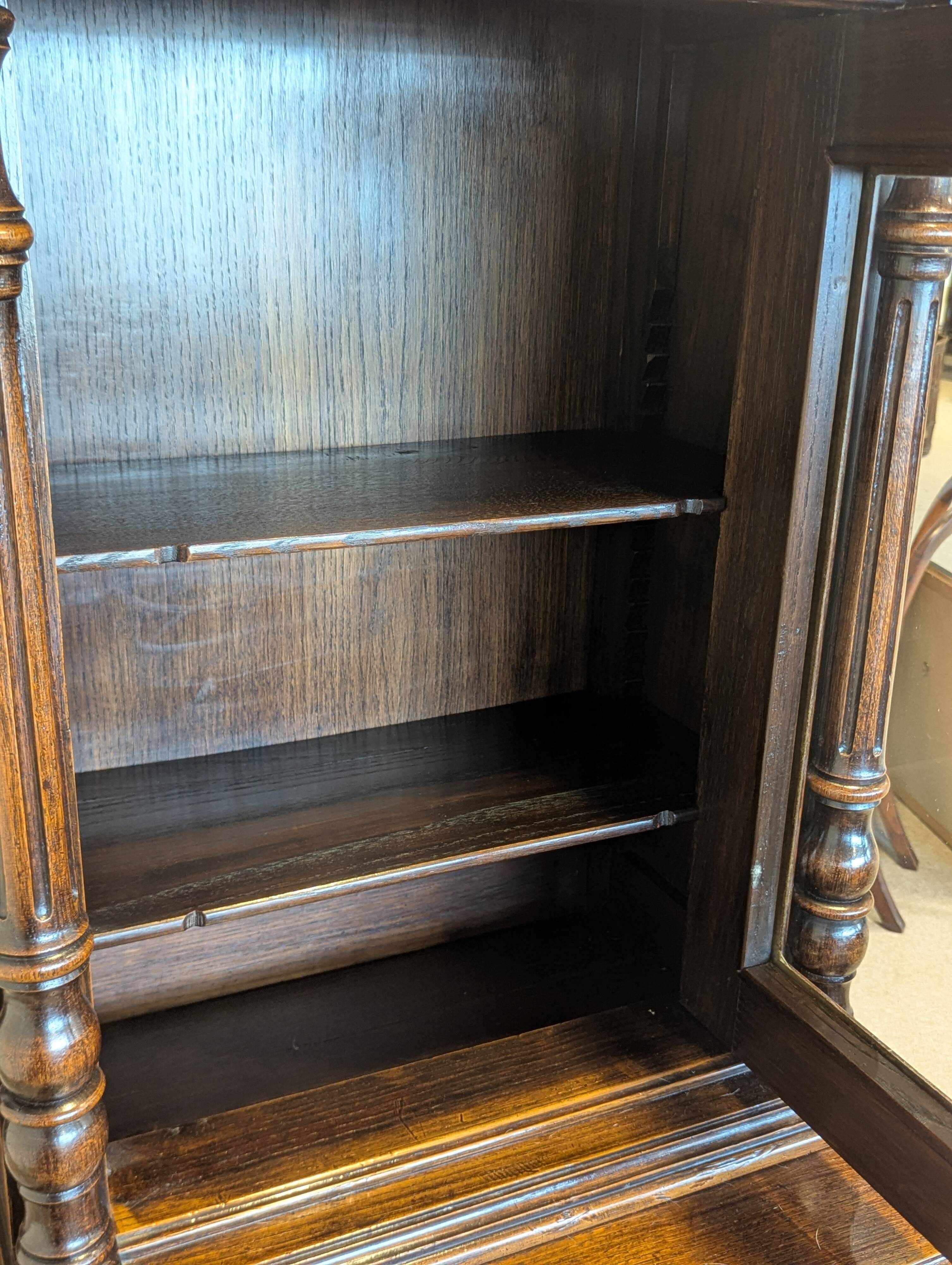 Two-body display cabinet in oak, Henri II style.
