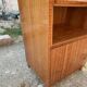 Brown trapezoidal wooden bar cabinet from the 1960s with a niche and lockable flap.