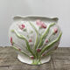 White ceramic pot cache in old flower slip