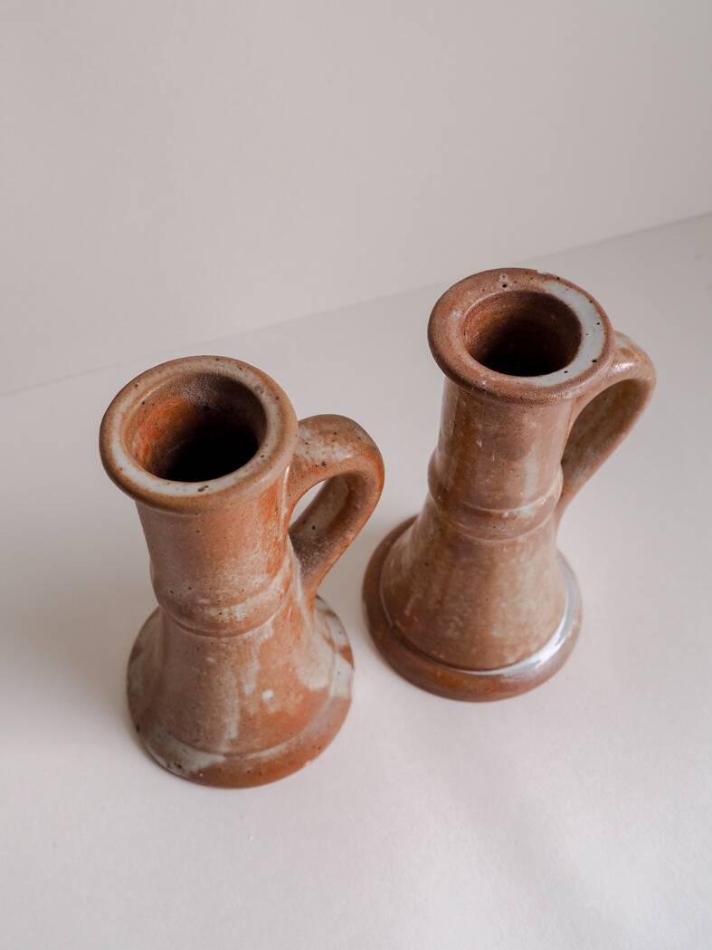 Set of two terracotta candle holders.