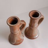 Set of two terracotta candle holders.