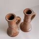 Set of two terracotta candle holders.