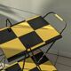 Vintage black and yellow checkered rolling bar trolley