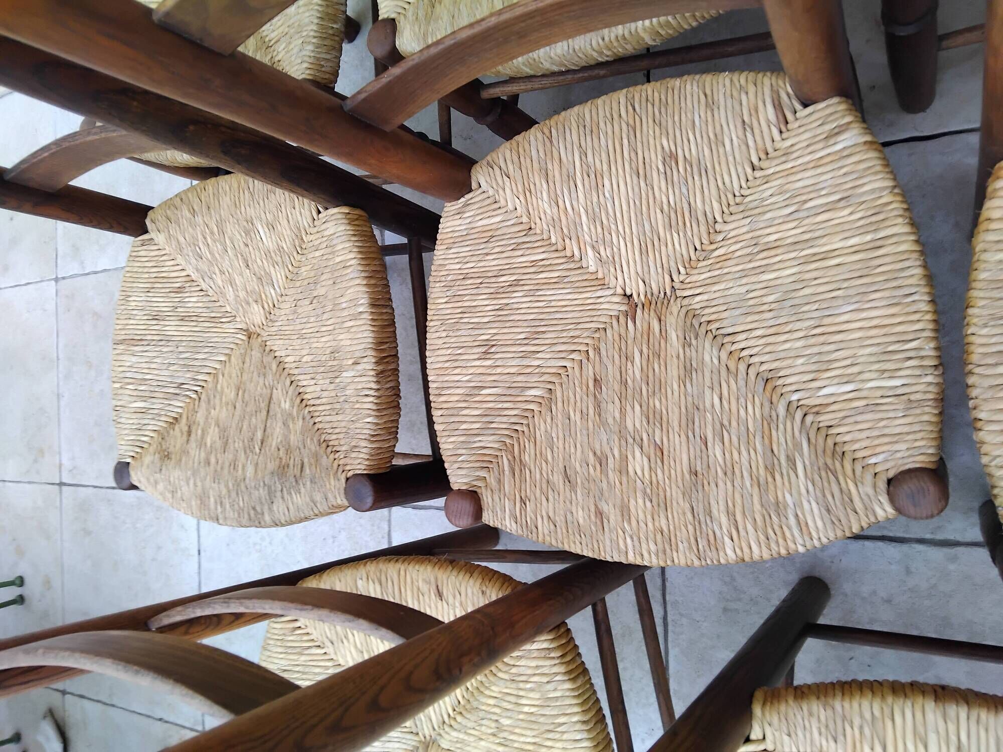 8 vintage straw chairs in the style of Charlotte Perriand.