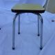 Two chairs and a yellow and blue stool in formica