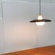 Minimalist metal and glass pendant lamp in mid-century style.