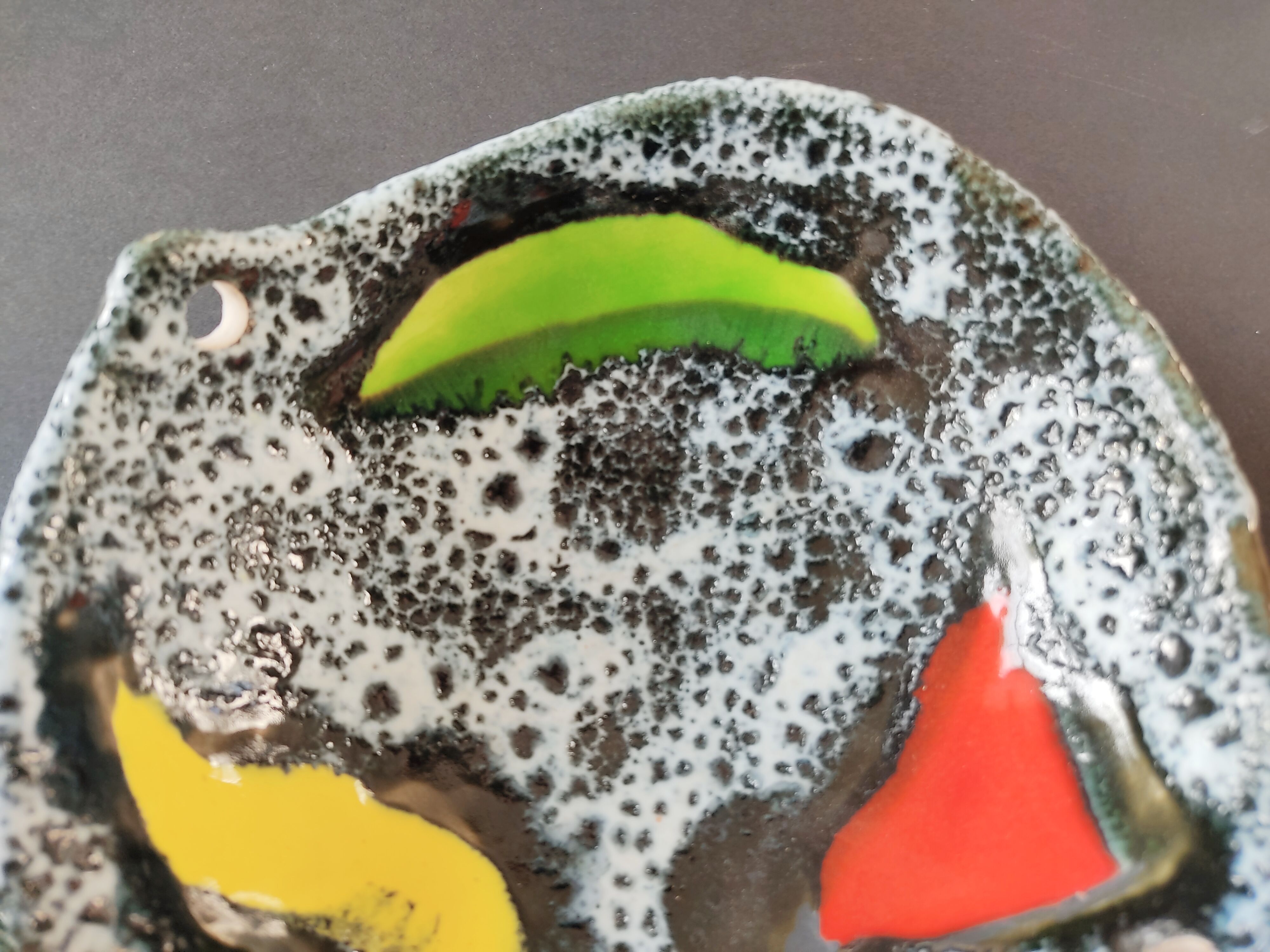 Empty black and white pocket with colored enamels