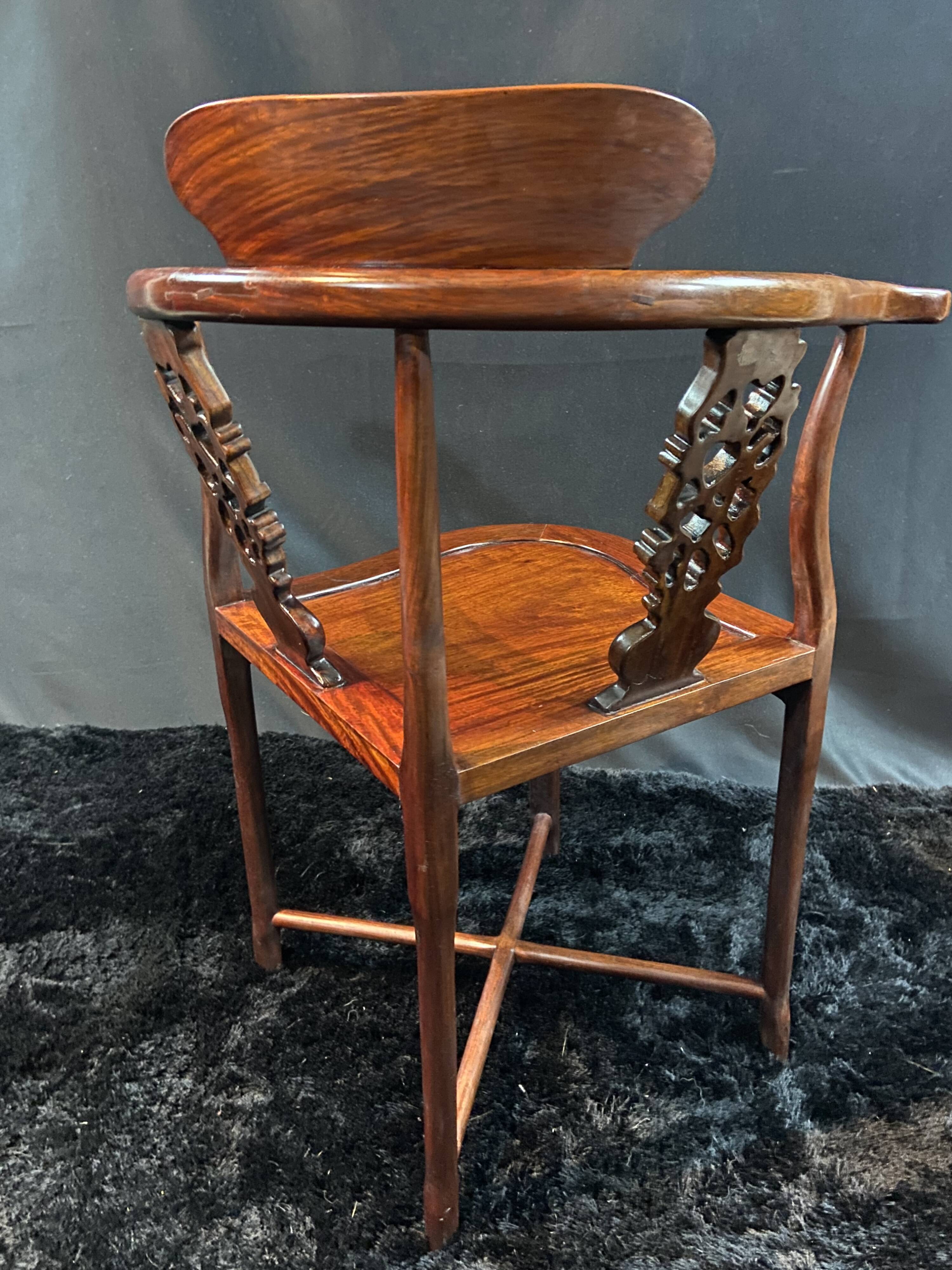 Corner armchair in solid wood with carved floral decoration featuring a bird.