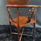 Corner armchair in solid wood with carved floral decoration featuring a bird.