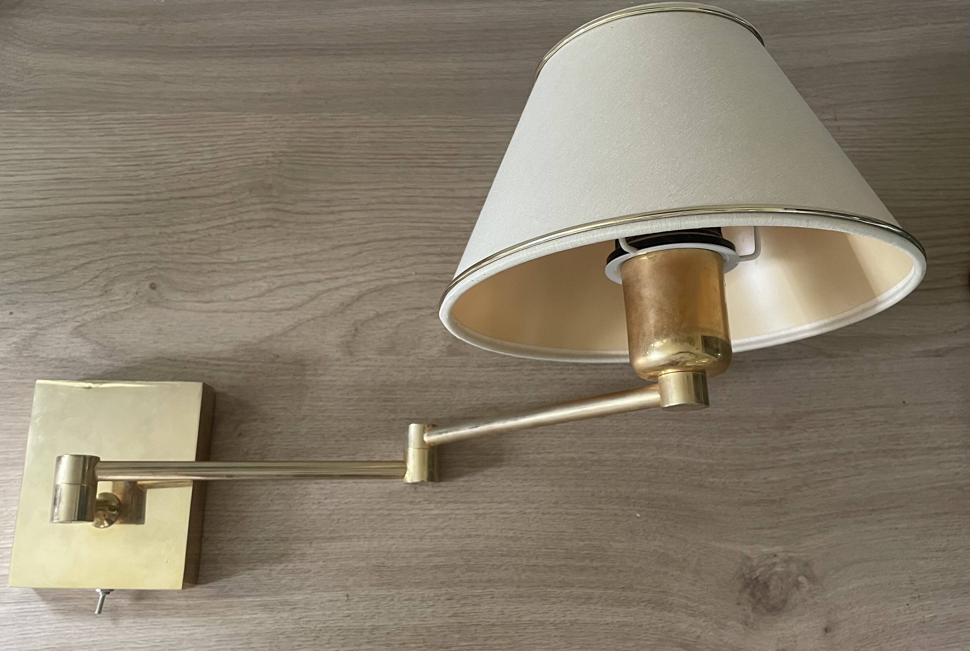 Pair of vintage brass wall lights with adjustable arms.