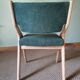 Scandinavian green chairs with tapered legs.