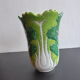 Ancient Asian ceramic vase green and white background decorated with butterflies