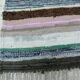 Vintage traditional nomadic kilim ethnic rug with multicoloured stripes.