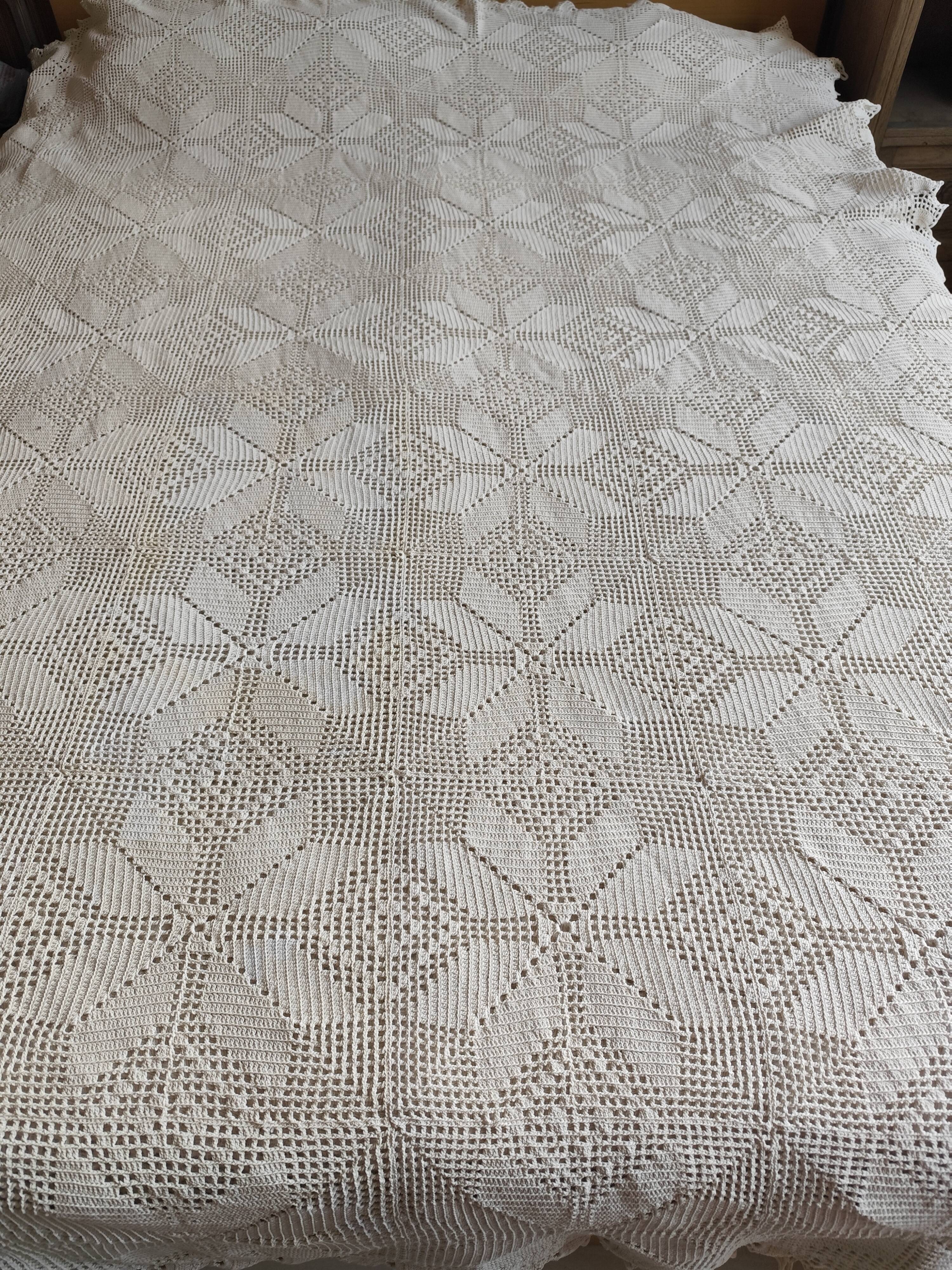 White cotton bedspread, crocheted sofa throw with star patterns