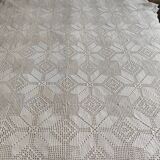 White cotton bedspread, crocheted sofa throw with star patterns