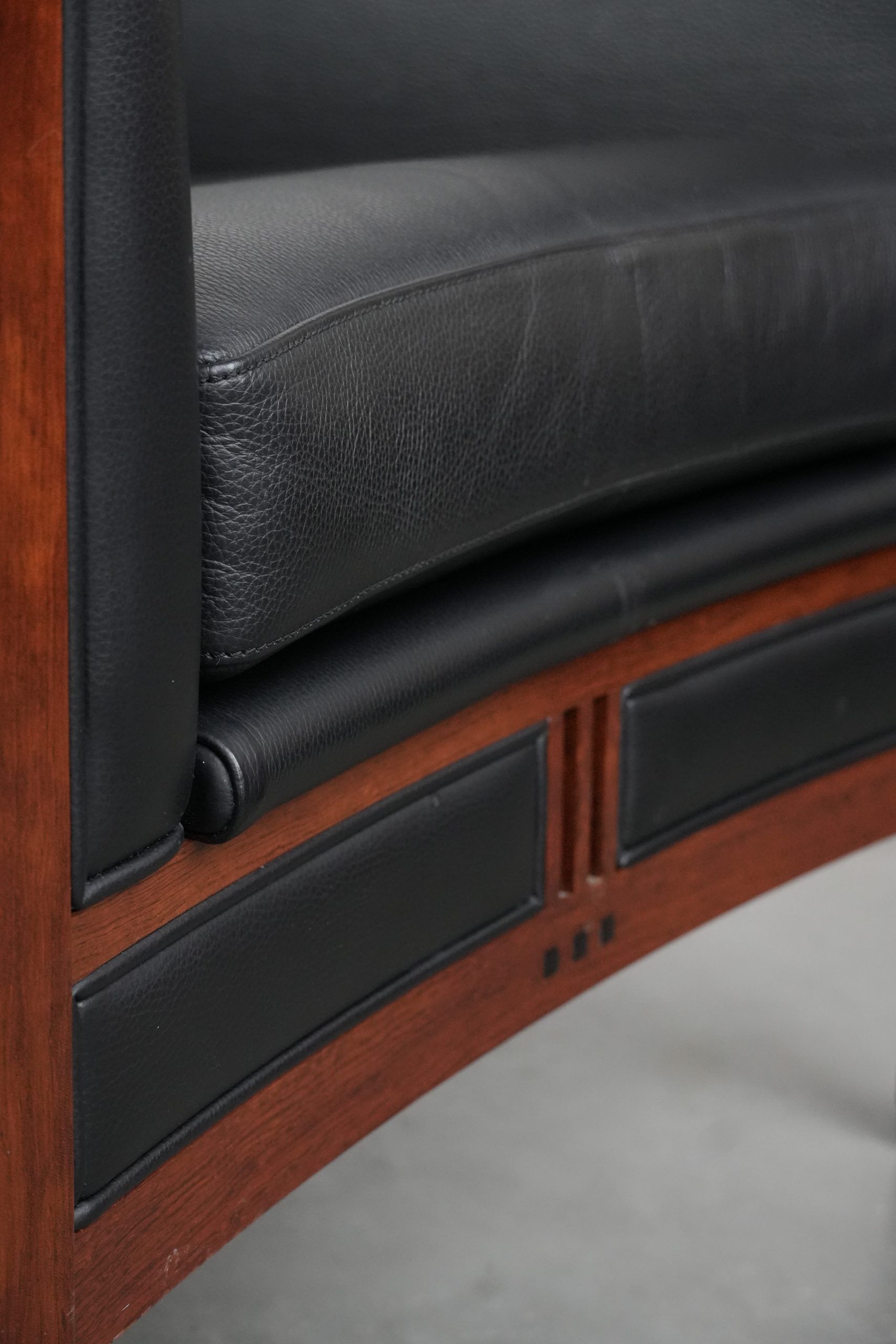 Art Deco design armchair with black leather with decorative stitching