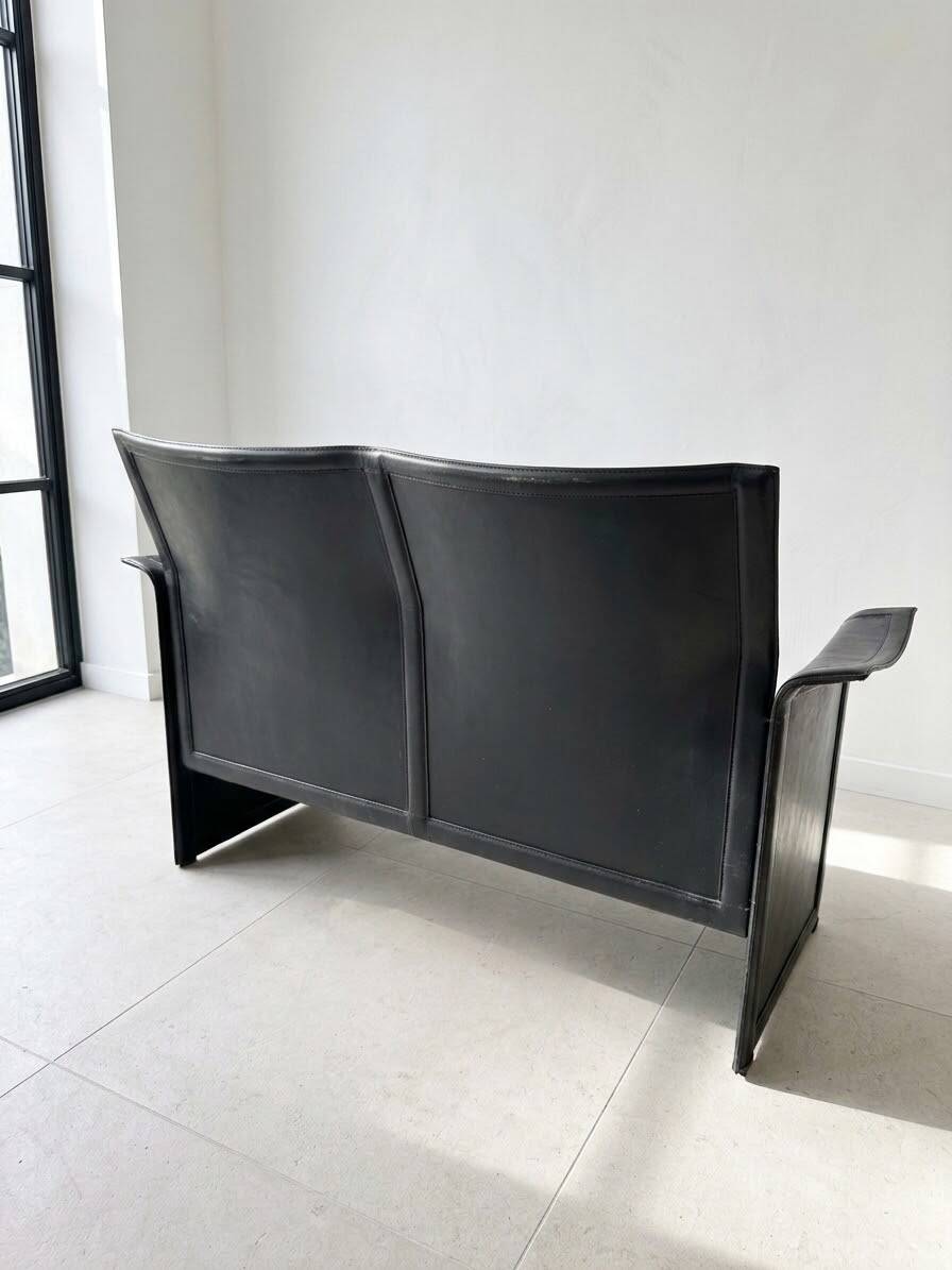 Small vintage black faux leather sofa
