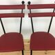 Pair of 1950s chairs in metal and red faux leather, Gueden-Adnet style.