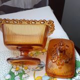 amber-colored pressed glass butter dish