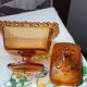 amber-colored pressed glass butter dish