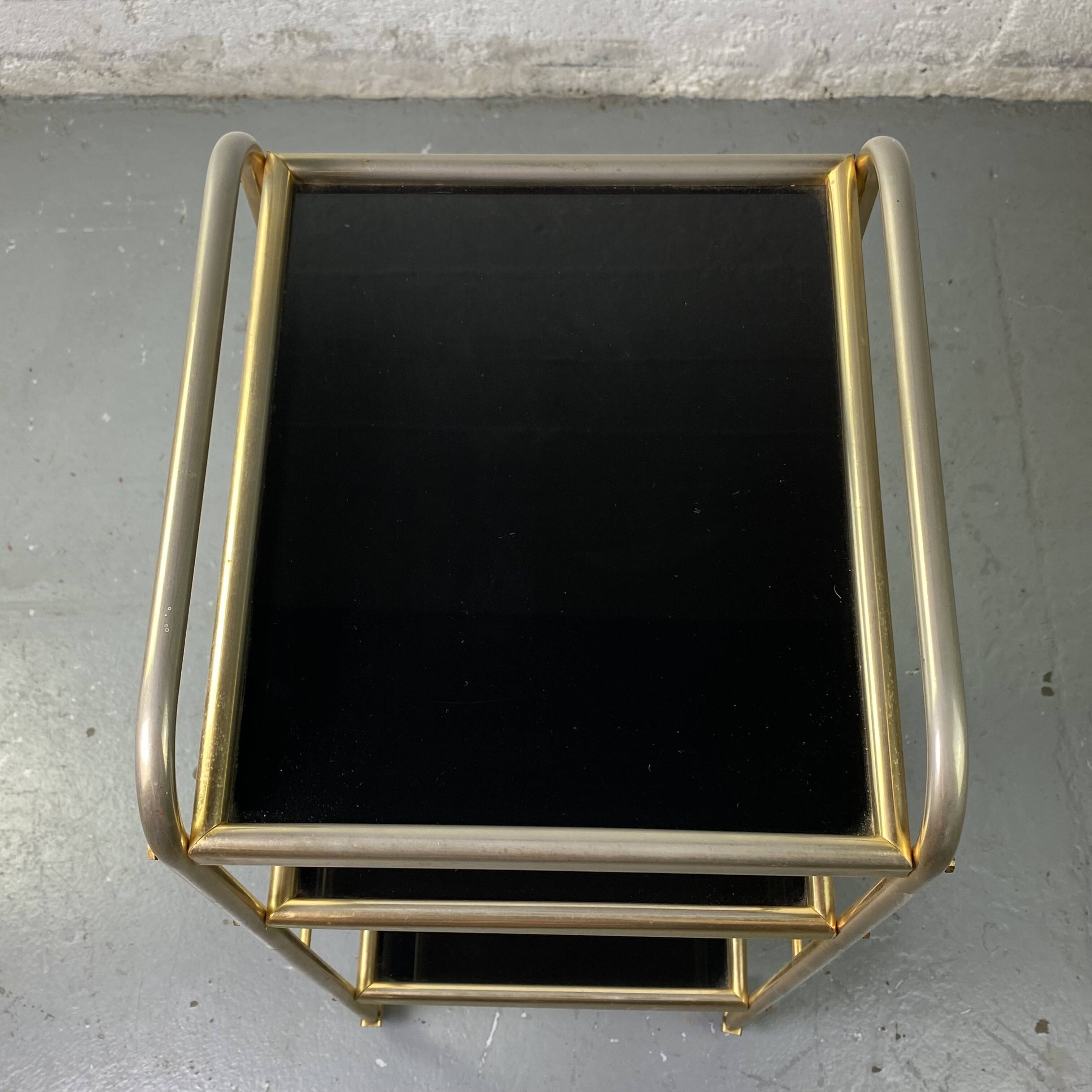 Small rolling trolley in brass and black plastic