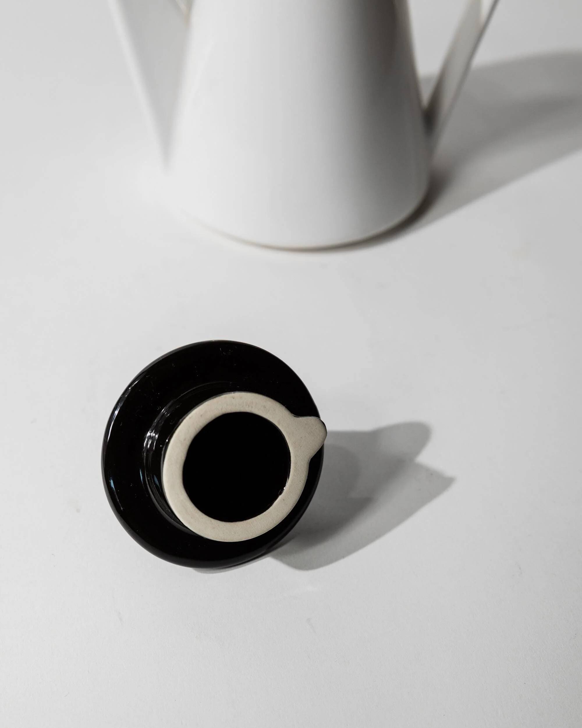 Vintage ceramic coffee pot or teapot from the 1980s, postmodern Memphis design, black and white triangles.