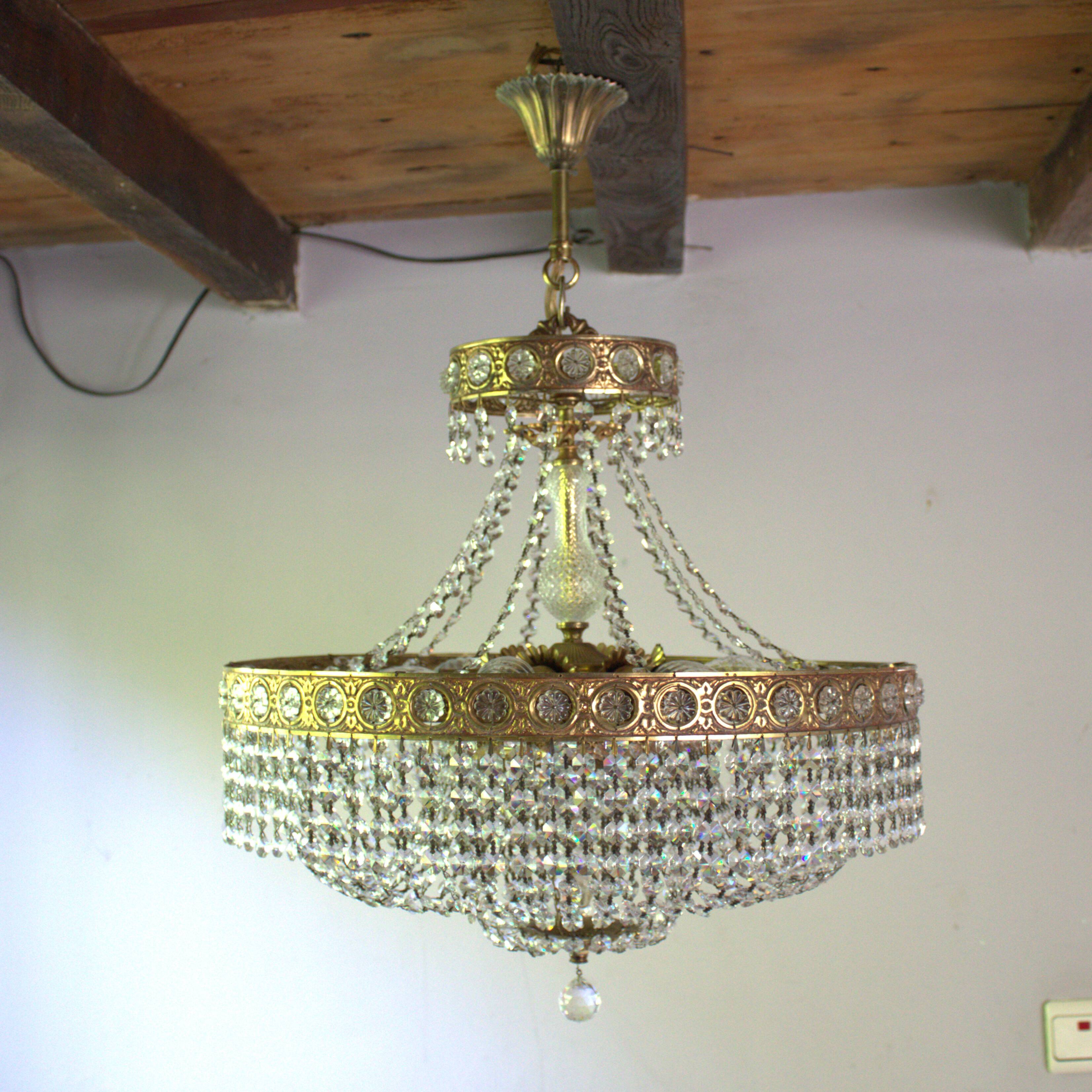 Antique castle style chandelier with tassels and floral details