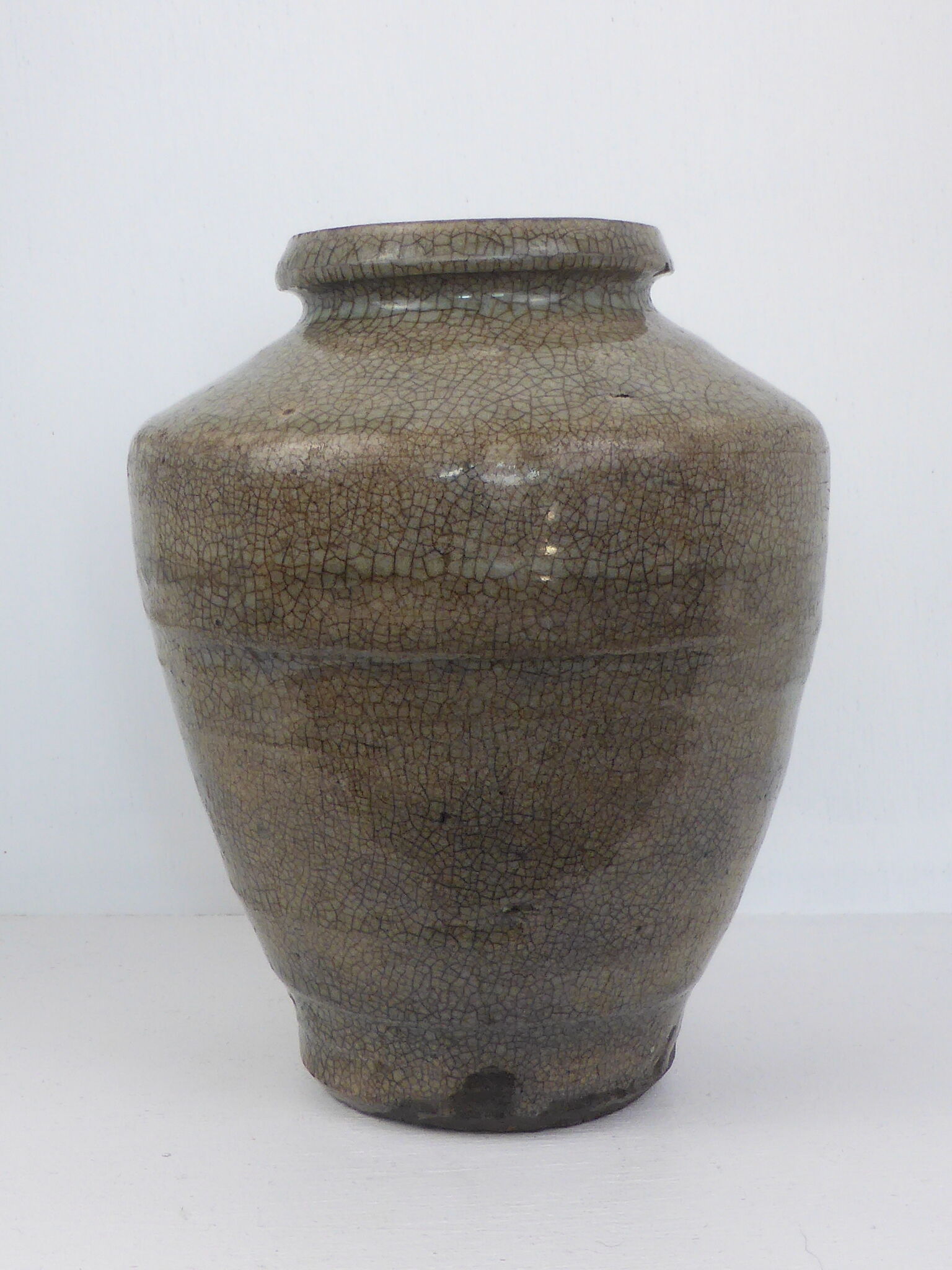 Ancient vase in khaki grey-green cracked sandstone